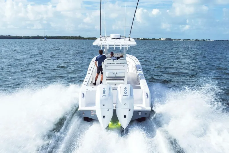 Slide: The Image of 2026 Invincible 33 Open Fisherman speeding on open water, rear view. - 7