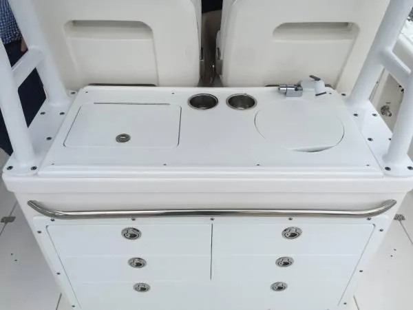 Slide: The Image of 2015 Edgewater 280CC boat console with storage compartments and cup holders. - 2