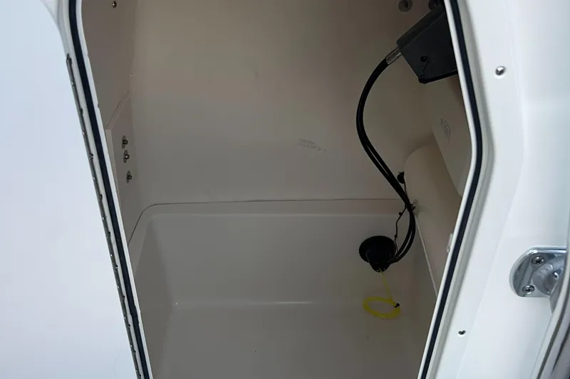 Slide: The Image of 2025 Bulls Bay 200 Center Console storage compartment interior. - 11