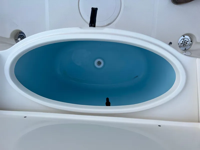 Slide: The Image of Bulls Bay 200 Center Console 2025 boat livewell with blue interior. - 4
