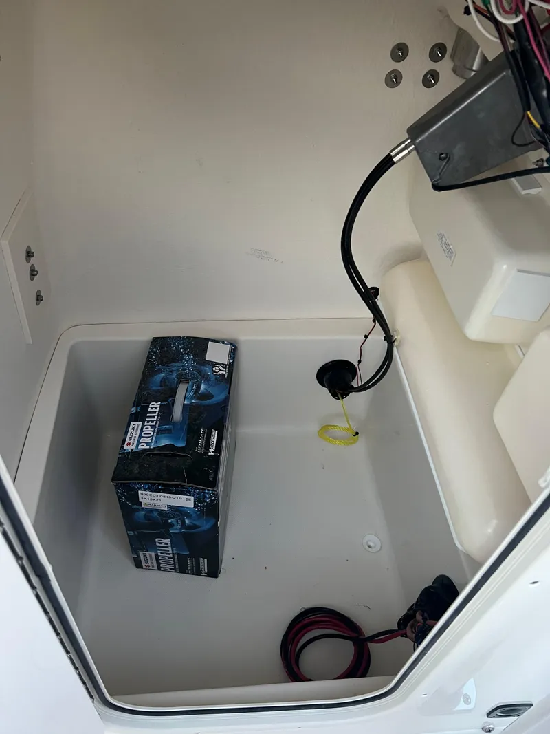 Slide: The Image of 2025 Bulls Bay 200 Center Console storage compartment with wiring and a battery box. - 5