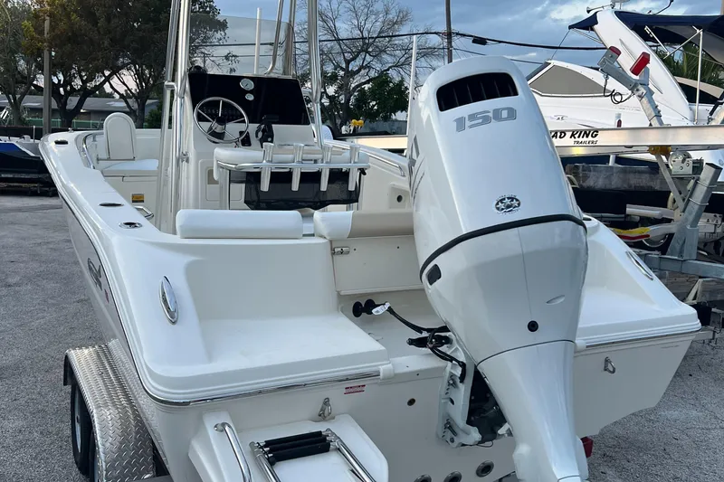 Slide: The Image of 2025 Bulls Bay 200 Center Console boat with 150 HP outboard motor, parked on trailer. - 6