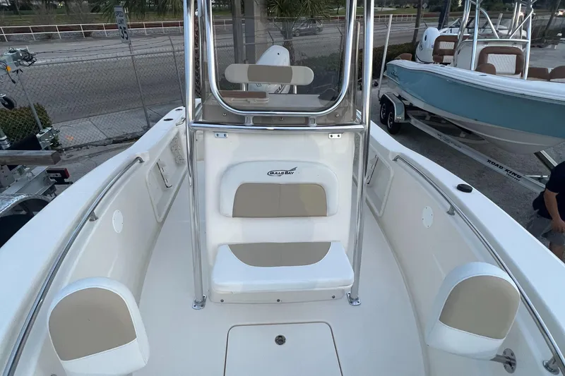 Slide: The Image of 2025 Bulls Bay 200 Center Console boat interior with seating and console view. - 8
