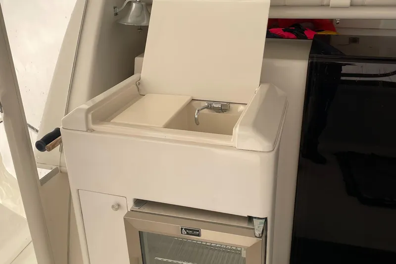 Slide: The Image of Compact sink and mini fridge on 2001 Carver 356 Aft Cabin Motor Yacht. - 14