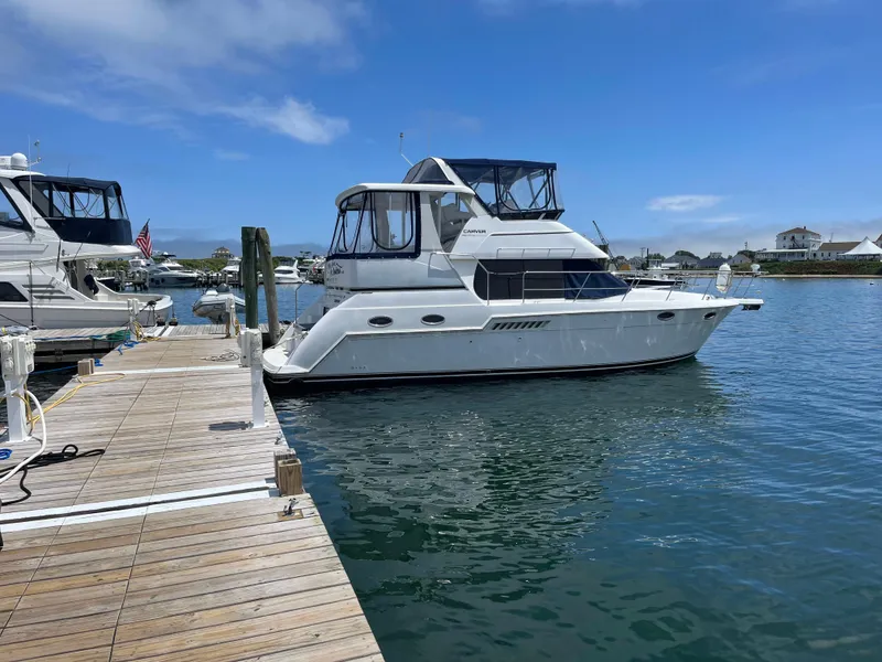 Slide: The Image of 2001 Carver 356 Aft Cabin Motor Yacht docked in a marina under clear blue skies. - 3