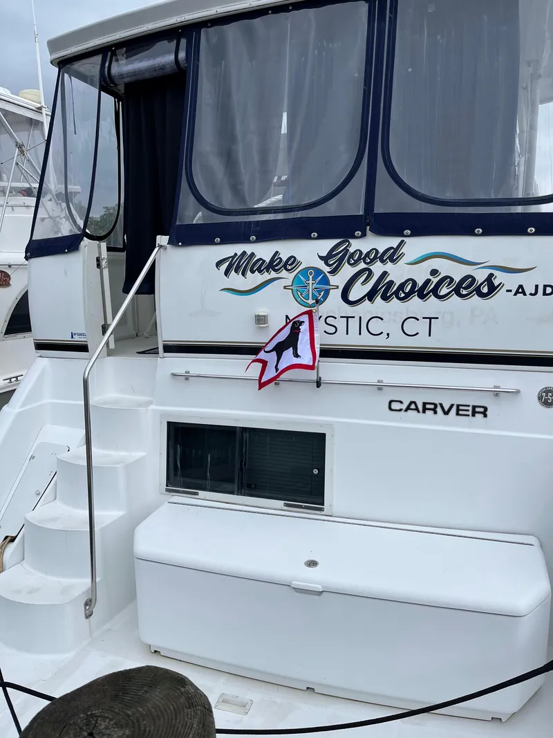 Slide: The Image of 2001 Carver 356 Aft Cabin Motor Yacht docked, featuring "Make Good Choices" signage, Mystic, CT. - 8