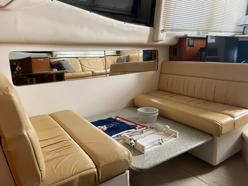 Slide: The Image of Interior of 2001 Carver 356 Aft Cabin Motor Yacht with beige seating and table. - 9