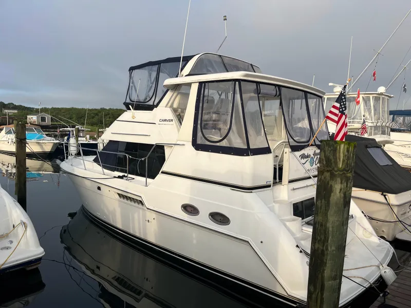 The Image of 2001 Carver 356 Aft Cabin Motor Yacht docked at marina, side view. - 0