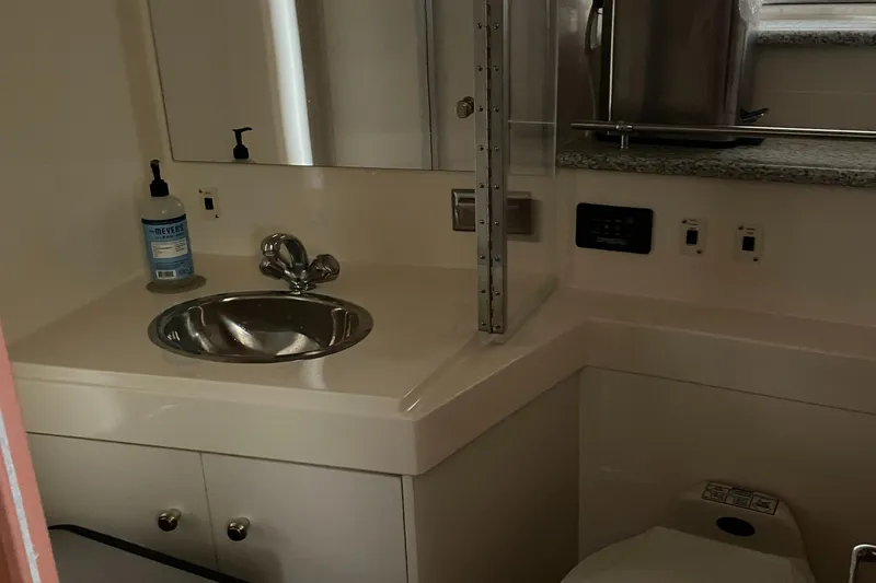 Slide: The Image of Bathroom interior of 2001 Carver 356 Aft Cabin Motor Yacht, featuring sink and toilet. - 13