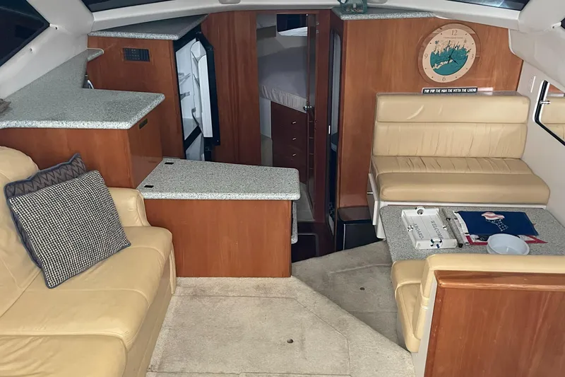 Slide: The Image of Interior of 2001 Carver 356 Aft Cabin Motor Yacht with beige seating and wood accents. - 17