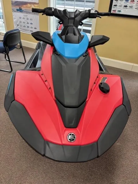 Slide: The Image of 2025 Yamaha WaveRunner JetBlaster DLX 3-Up in showroom, red and blue design. - 6