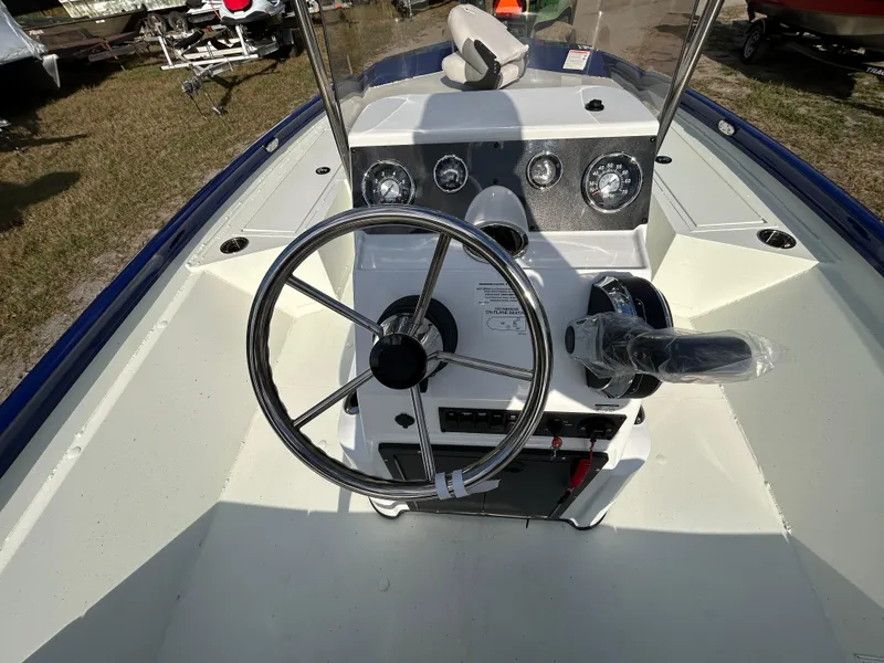 Slide: The Image of 2025 Crestliner 2000 Bay boat dashboard with steering wheel and control panel. - 8