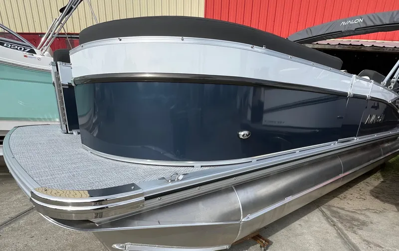 The Image of 2024 Avalon Catalina Elite 23' pontoon boat, sleek design, docked outdoors. - 0