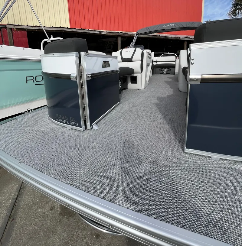 Slide: The Image of 2024 Avalon Catalina Elite 23' pontoon boat with spacious deck and modern seating. - 3