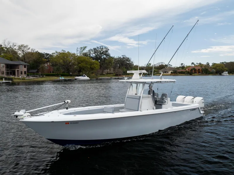 Slide: The Image of 2022 Contender 35ST boat cruising on a calm river with fishing rods. - 13