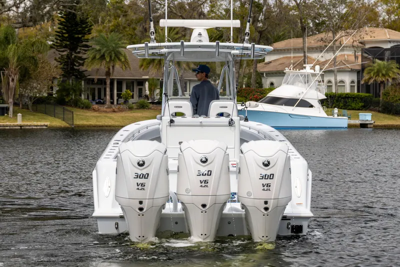 Slide: The Image of 2022 Contender 35ST boat with triple Yamaha 300 V6 engines on a calm waterway. - 3