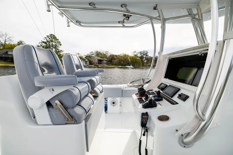 Slide: The Image of 2022 Contender 35ST boat interior with dual seats and advanced navigation controls. - 39