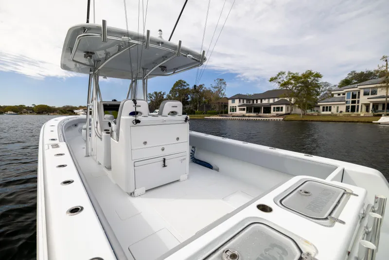 Slide: The Image of 2022 Contender 35ST boat on calm water, showcasing spacious deck and modern design. - 42