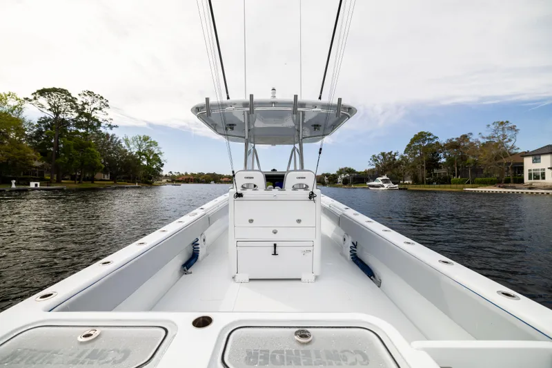 Slide: The Image of 2022 Contender 35ST boat on calm water, showcasing spacious deck and sleek design. - 44