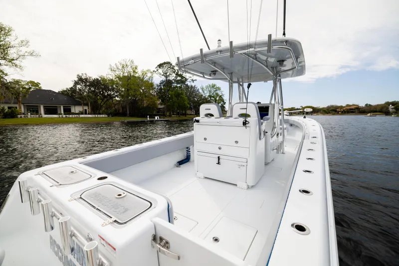 Slide: The Image of 2022 Contender 35ST boat on calm water, showcasing spacious deck and sleek design. - 45