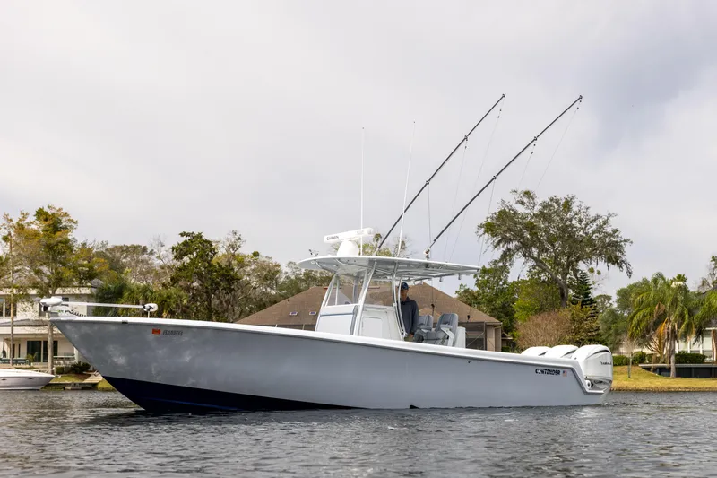 Slide: The Image of 2022 Contender 35ST boat on water, featuring sleek design and fishing rods. - 5