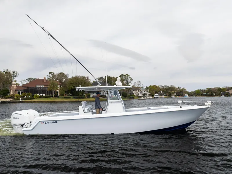 Slide: The Image of 2022 Contender 35ST boat on water, side view, with fishing rods and scenic background. - 8