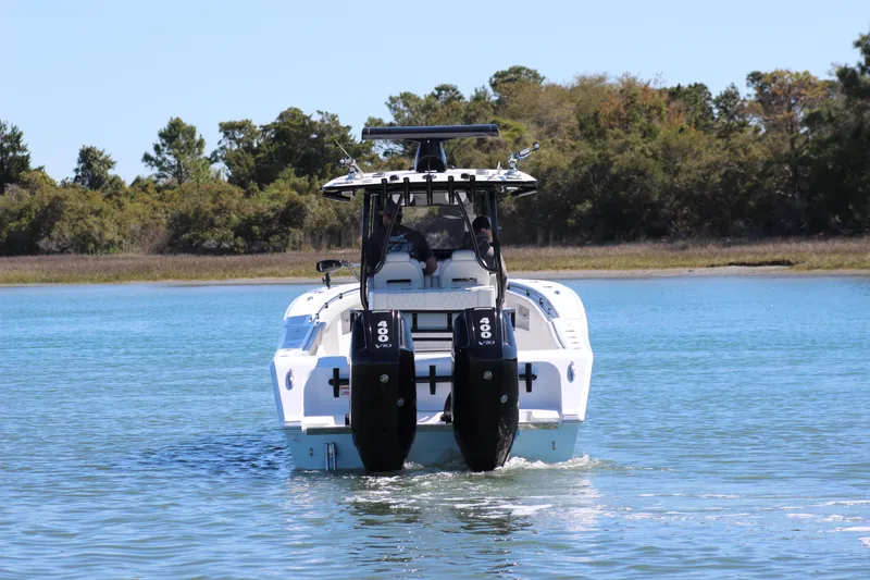 Slide: The Image of 2024 Front Runner 33 Center Console boat on water, rear view with twin engines. - 11