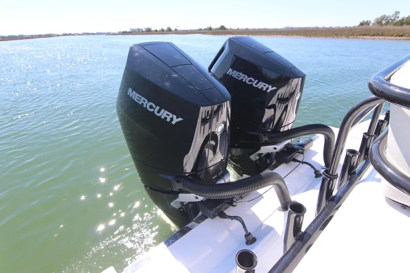 Slide: The Image of 2024 Front Runner 33 Center Console with dual Mercury outboard engines on water. - 12