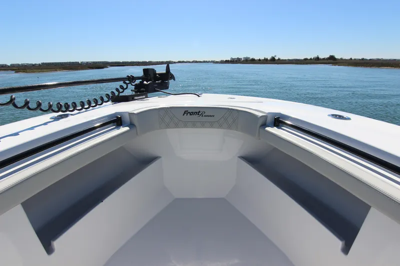 Slide: The Image of 2024 Front Runner 33 Center Console boat on calm water, showcasing spacious deck design. - 14