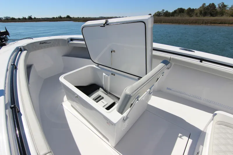 Slide: The Image of 2024 Front Runner 33 Center Console boat with open storage compartment on deck. - 17