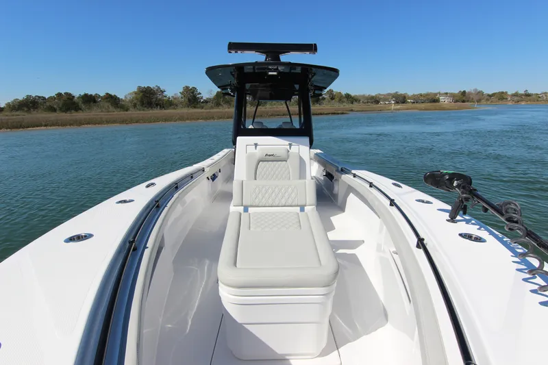 Slide: The Image of 2024 Front Runner 33 Center Console boat on calm water, showcasing sleek design and spacious seating. - 19