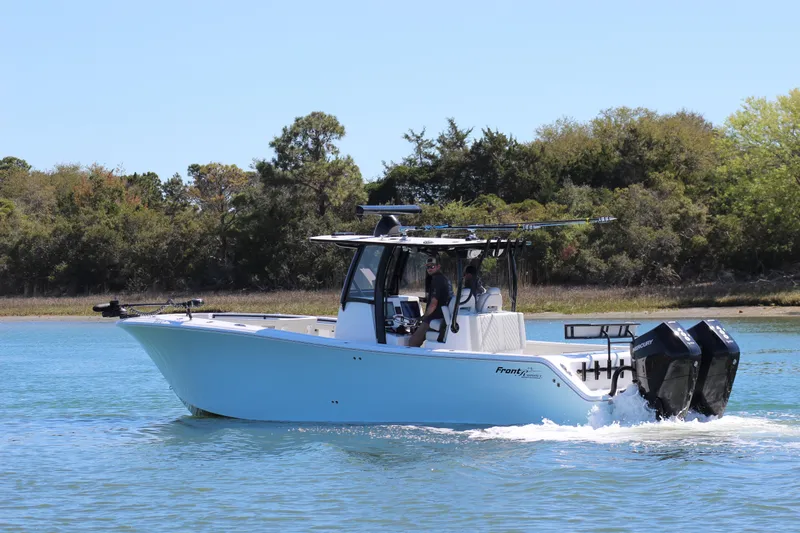 Slide: The Image of 2024 Front Runner 33 Center Console boat cruising on a calm lake. - 2