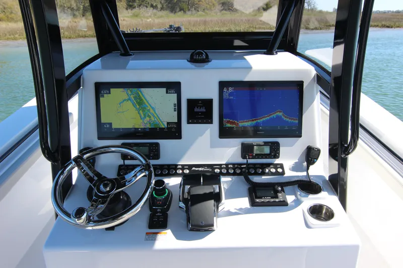 Slide: The Image of 2024 Front Runner 33 Center Console boat dashboard with navigation screens and controls. - 24