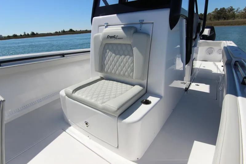 Slide: The Image of 2024 Front Runner 33 Center Console boat with cushioned seating, on a sunny day. - 25