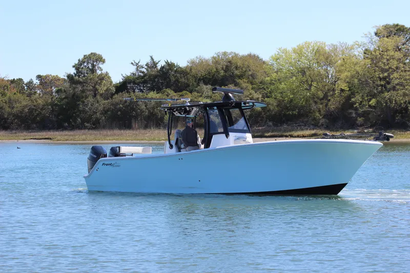 Slide: The Image of 2024 Front Runner 33 Center Console boat cruising on a calm lake. - 3