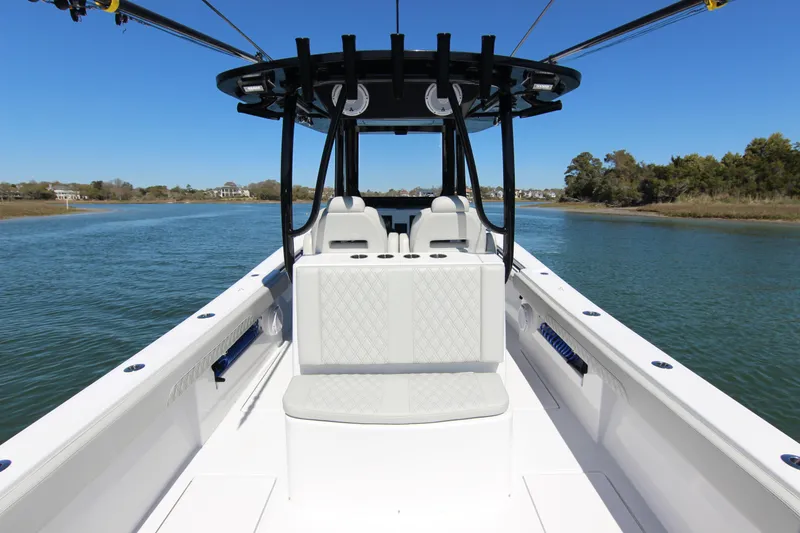 Slide: The Image of 2024 Front Runner 33 Center Console boat on calm water, showcasing sleek design and spacious seating. - 32