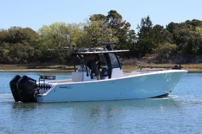 Slide: The Image of 2024 Front Runner 33 Center Console boat cruising on a calm lake. - 4