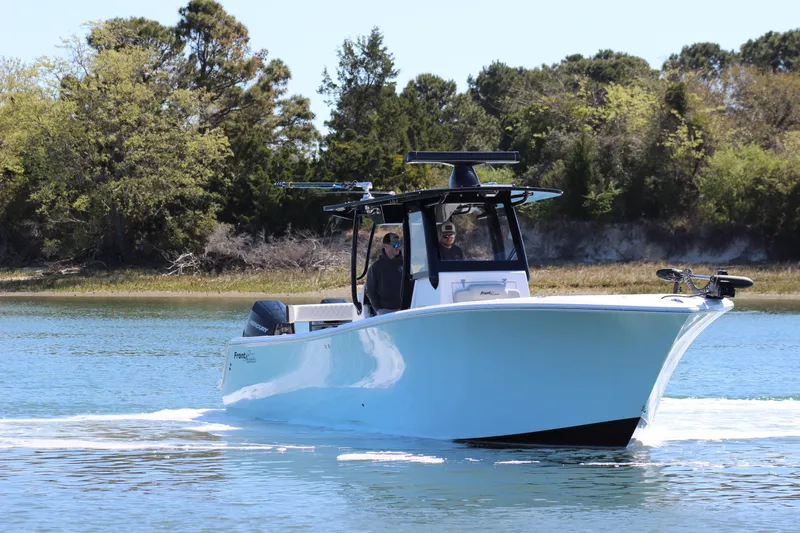 Slide: The Image of 2024 Front Runner 33 Center Console boat cruising on a calm lake. - 9