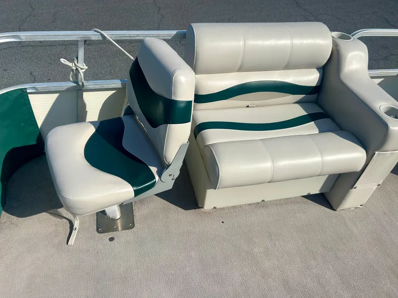Slide: The Image of 2003 Odyssey Pontoons 2101 Millennium boat seating with green and white upholstery. - 12