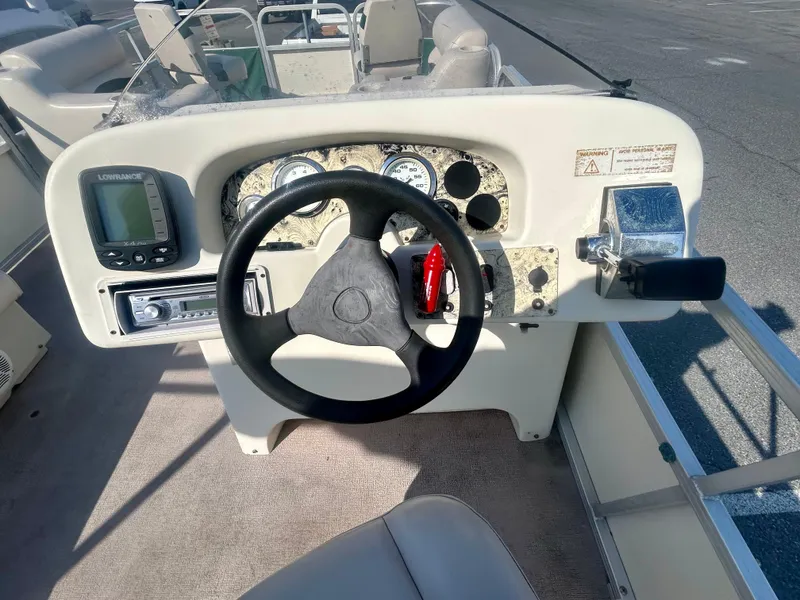 Slide: The Image of 2003 Odyssey Pontoons 2101 Millennium dashboard with steering wheel and controls. - 13