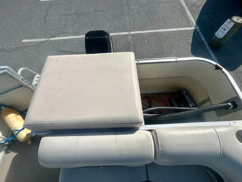 Slide: The Image of 2003 Odyssey Pontoons 2101 Millennium boat interior with cushioned seating and storage compartment. - 14
