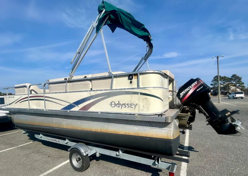 Slide: The Image of 2003 Odyssey Pontoons 2101 Millennium on trailer with Mercury outboard motor. - 2