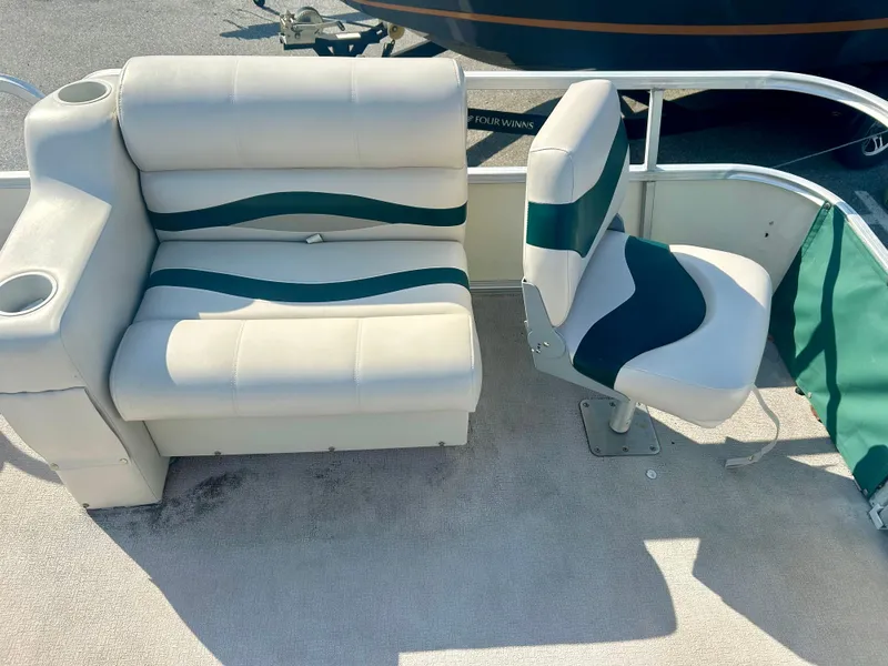 Slide: The Image of 2003 Odyssey Pontoons 2101 Millennium boat seating with white and green upholstery. - 6