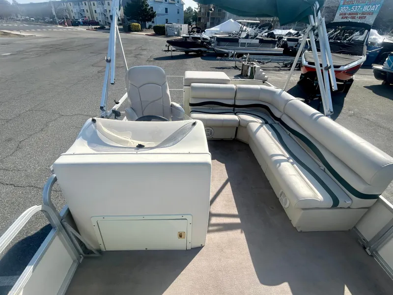 Slide: The Image of 2003 Odyssey Pontoons 2101 Millennium with spacious seating and helm, docked outdoors. - 7