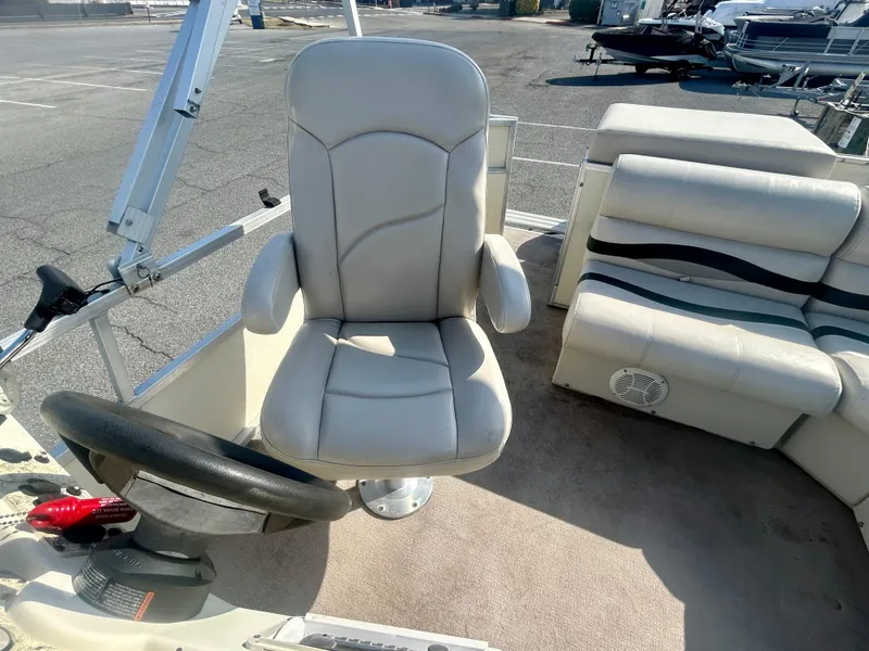 Slide: The Image of 2003 Odyssey Pontoons 2101 Millennium boat interior with steering wheel and seating. - 8