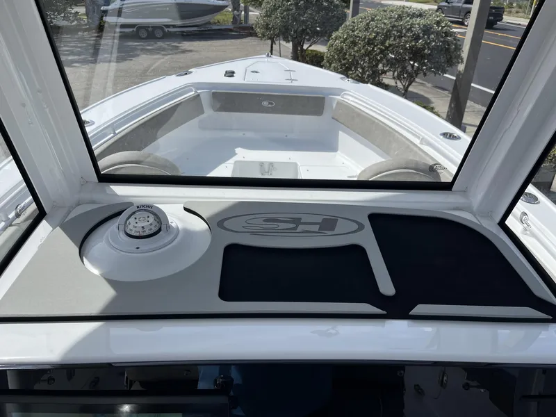 Slide: The Image of 2025 Sea Hunt Ultra 265 SE boat interior with compass and dashboard view. - 13