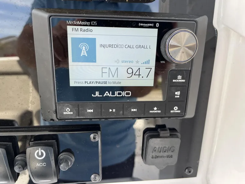 Slide: The Image of JL Audio MediaMaster 105 displaying FM radio on Sea Hunt Ultra 265 SE, 2025 model. - 14