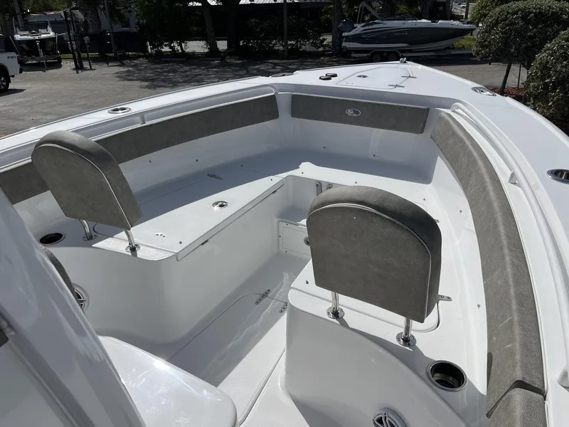 Slide: The Image of 2025 Sea Hunt Ultra 265 SE boat interior with cushioned seating and cup holders. - 16