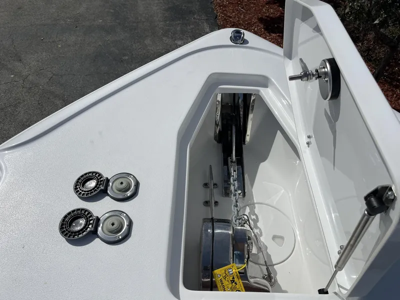 Slide: The Image of Anchor compartment of 2025 Sea Hunt Ultra 265 SE boat, featuring chain and hardware. - 18