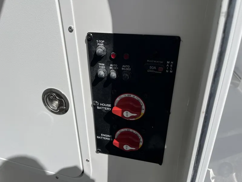 Slide: The Image of Control panel of 2025 Sea Hunt Ultra 265 SE boat, featuring battery switches and power controls. - 24